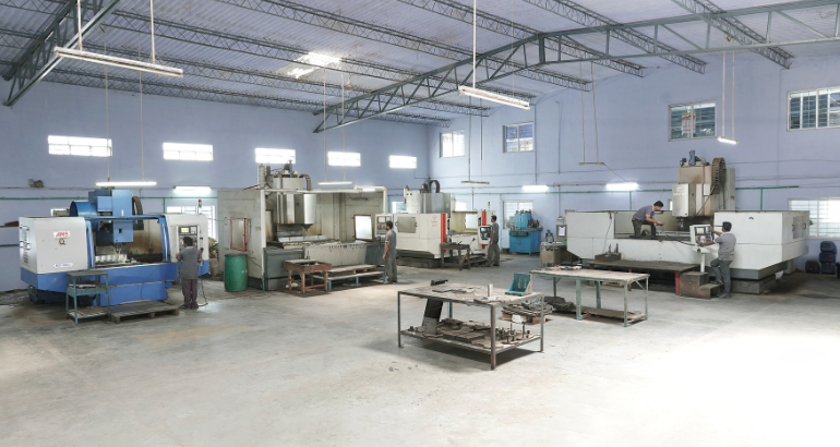 A large industrial complex with various machinery and equipment and skilled employees involved in making patterns