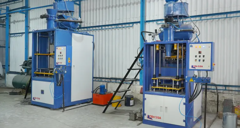 Two high-pressure hydraulic press machines in a huge manufacturing facility for precise and accurate castings.