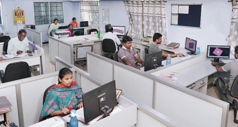 An office area with a set of professionals working at their computers in CAD/CAM designing for 3D pattern modeling