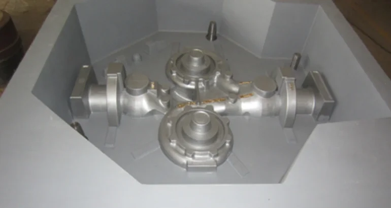 A mechanical casting apparatus made of metal that has four internal valves for use in industrial applications